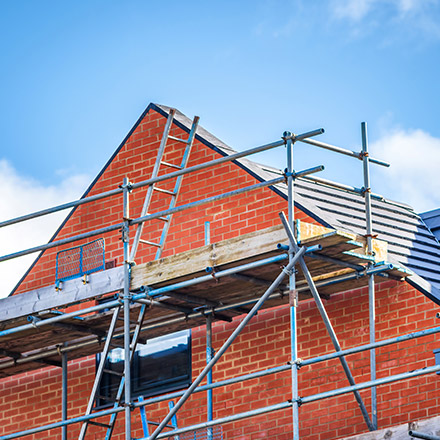 Scaffolding Injuries - Picture of a red brick house with scaffolding erected.